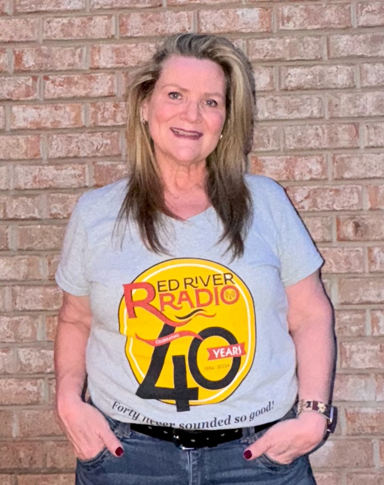 A blonde woman wearing a Red River Radio 40th anniversary T-shirt