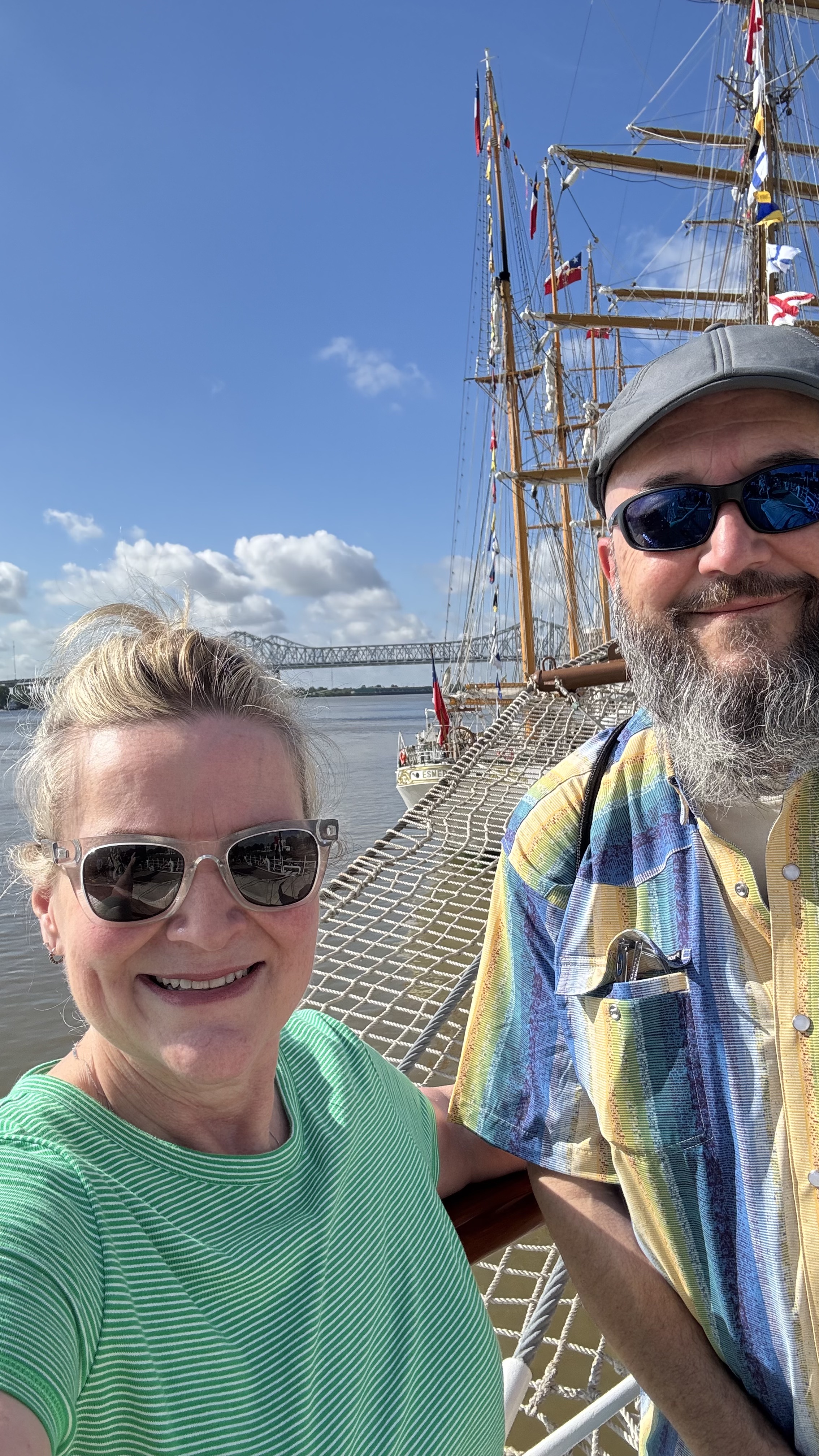 A man and woman standing in front of Sail250 Tall Ships
