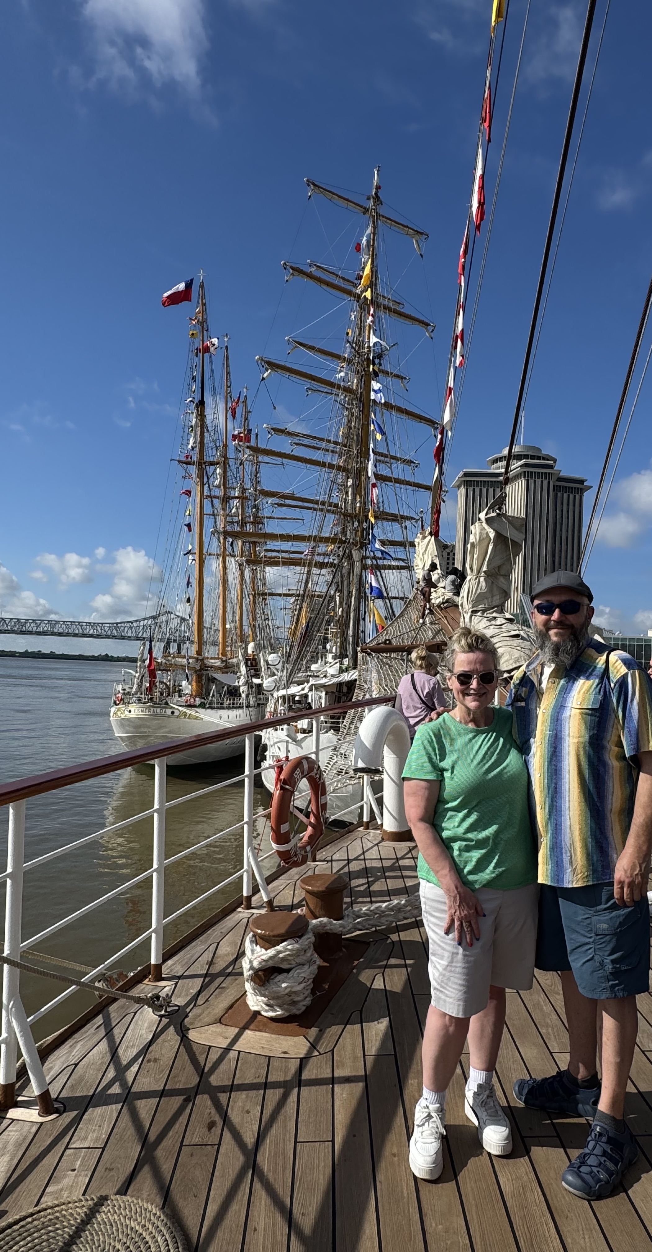 A man and woman standing in front of Sail250 Tall Ships