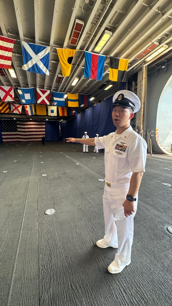 A Naval officer giving a tour on the USS Kearsarge