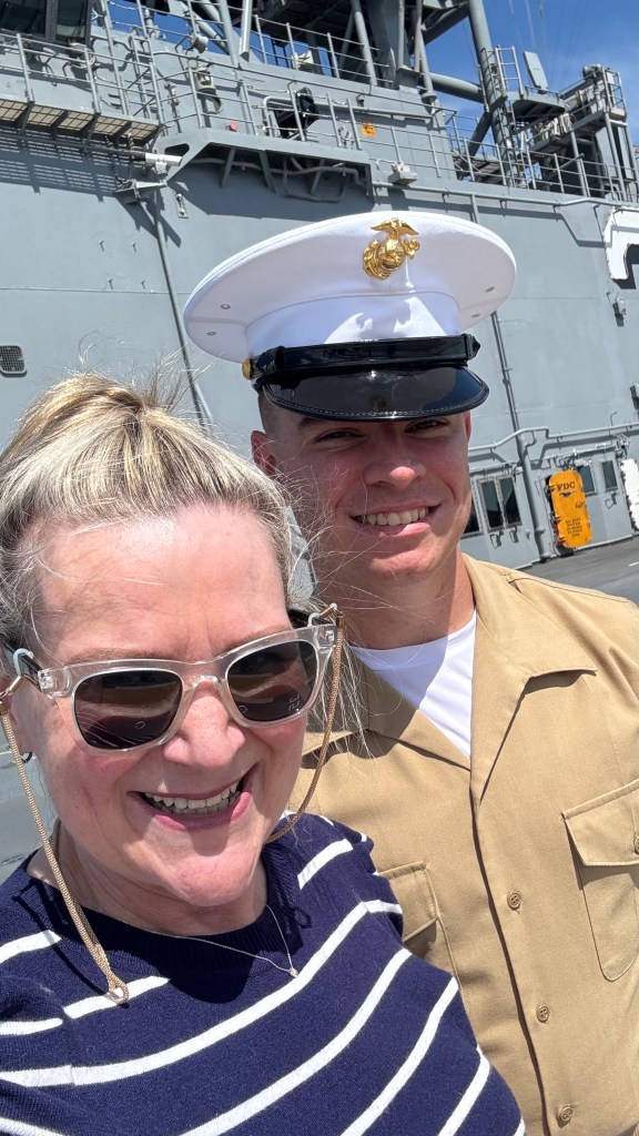 A woman with a Marine on the flight deck of the USS Kearsarge