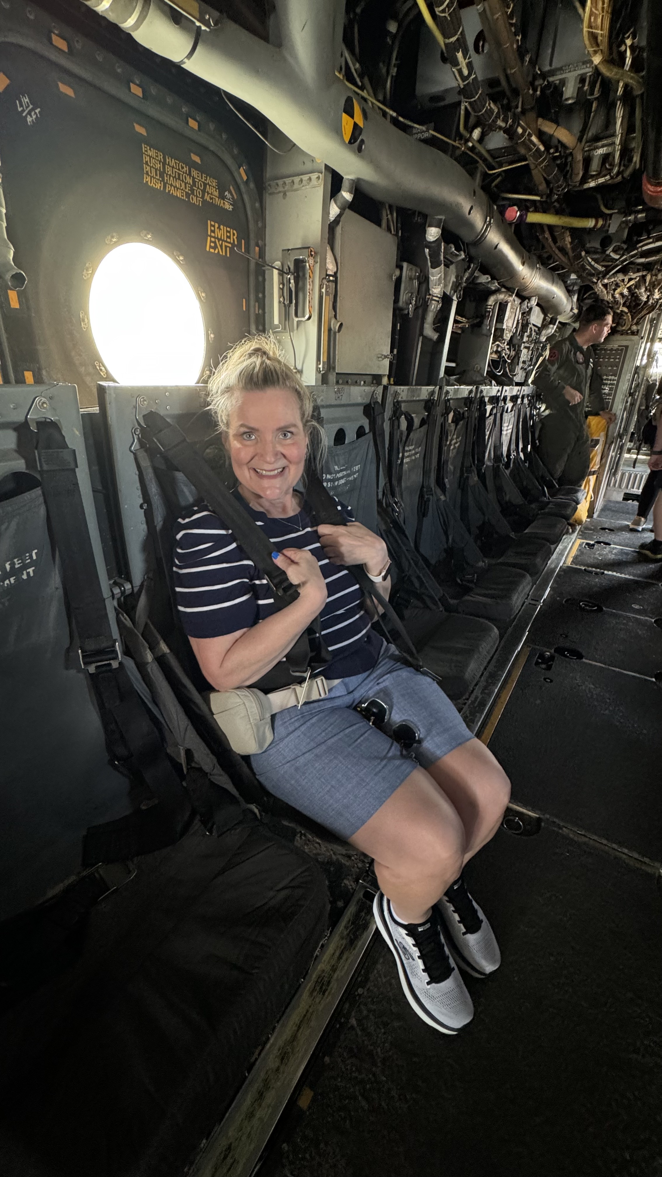 a woman in a seat of a military flight vehicle