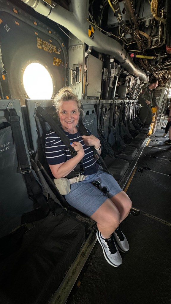 a woman in a seat of a military flight vehicle