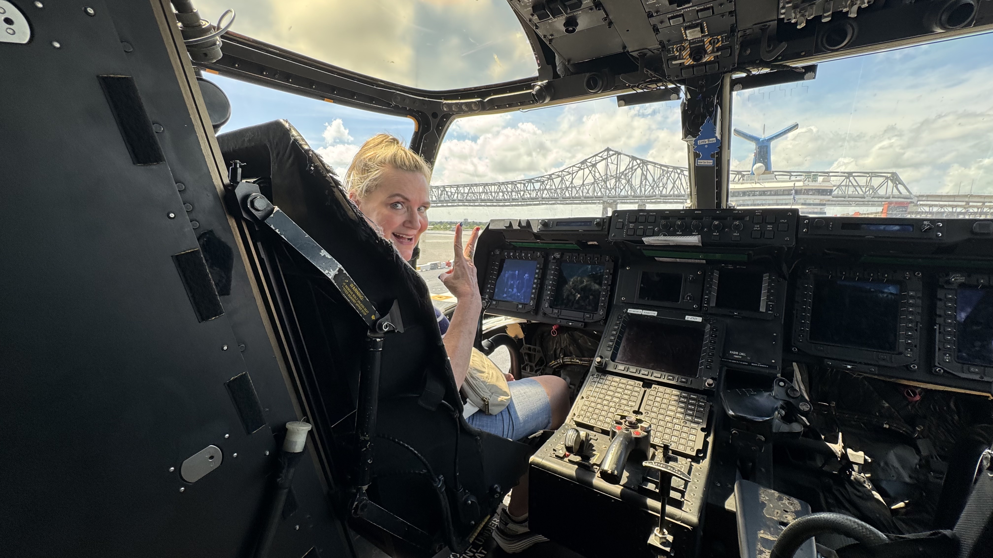 a woman in the flight seat of a military vehicle